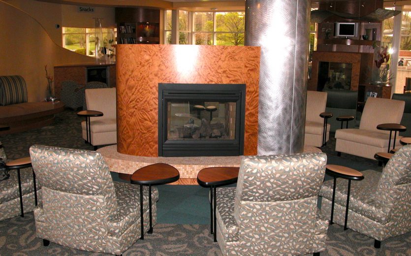 Custom fireplace surround with exotic wood veneer — ER waiting area